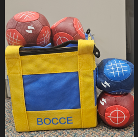 image of 3 red and one blue bocce ball on top of yellow carrying case